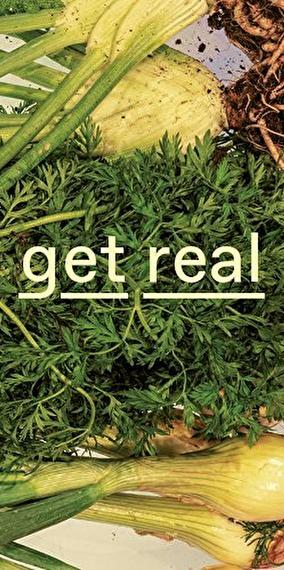Various fresh vegetables superimposed with the text “get real”